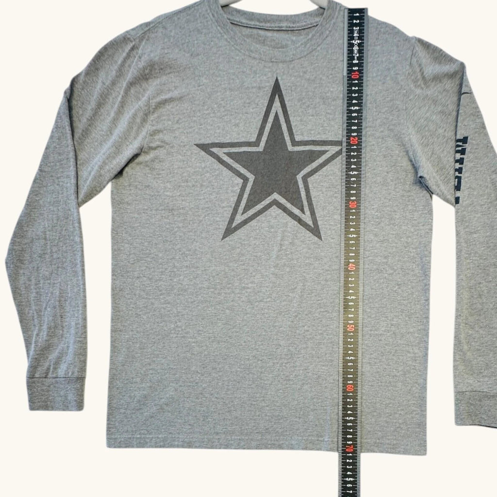 Nike grey long sleeve top featuring Dallas Cowboys star graphic print on soft knit fabric.