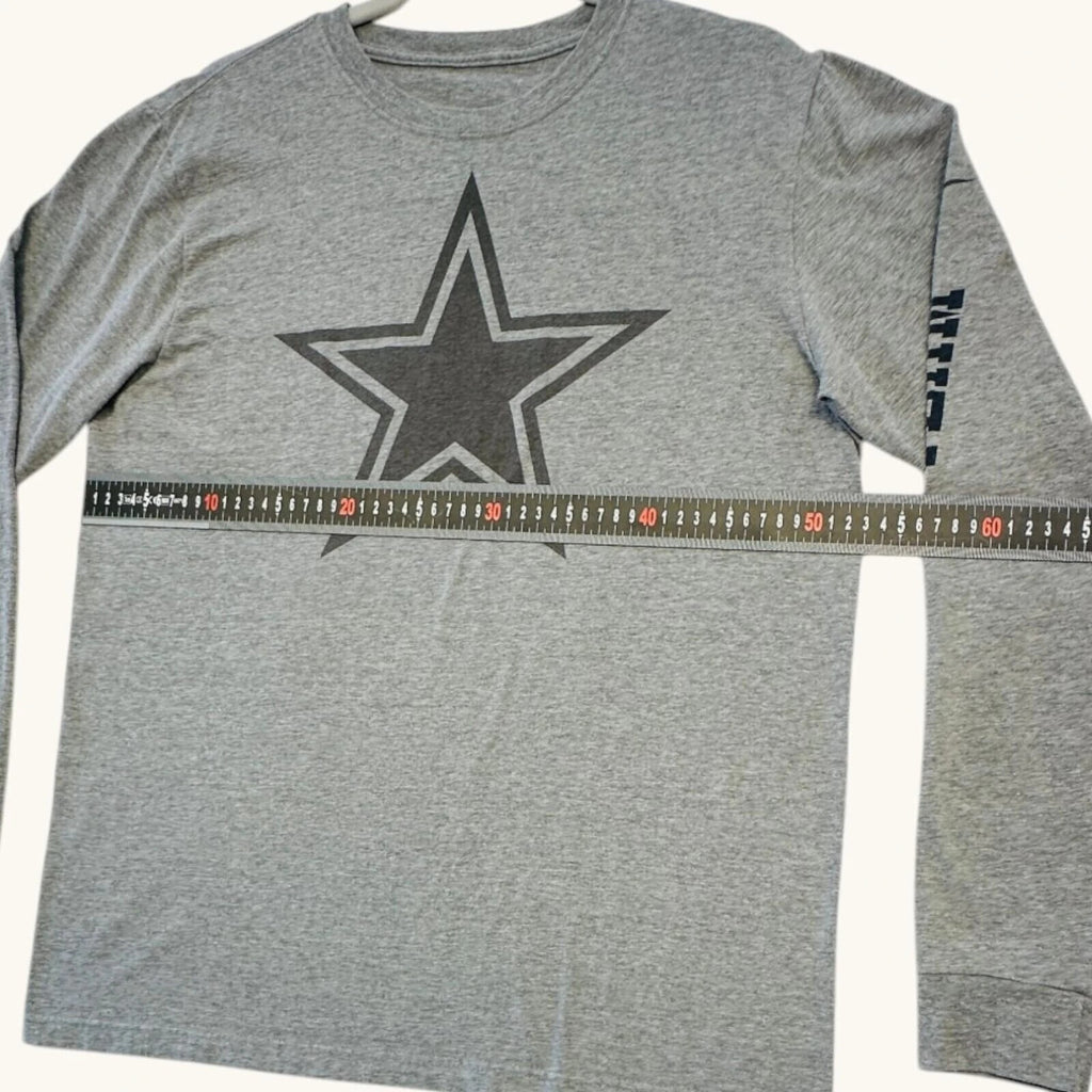 Nike grey long sleeve top featuring Dallas Cowboys star graphic print on soft knit fabric.