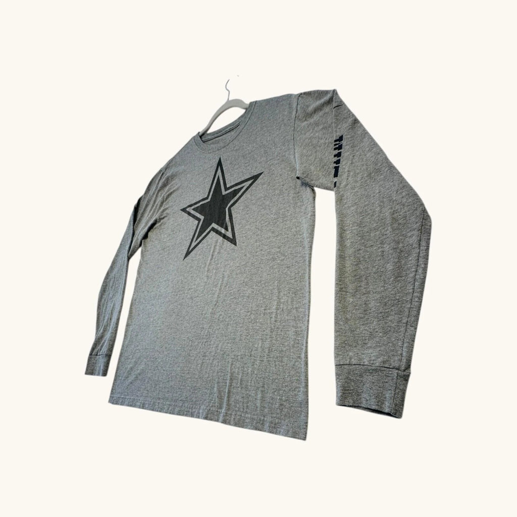 Nike grey long sleeve top featuring Dallas Cowboys star graphic print on soft knit fabric.