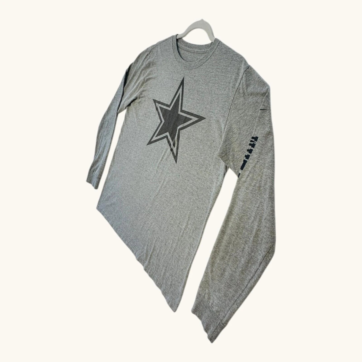 Nike grey long sleeve top featuring Dallas Cowboys star graphic print on soft knit fabric.