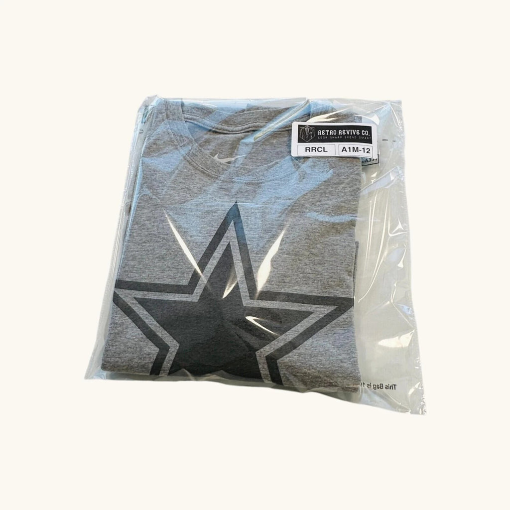 Nike grey long sleeve top featuring Dallas Cowboys star graphic print on soft knit fabric.