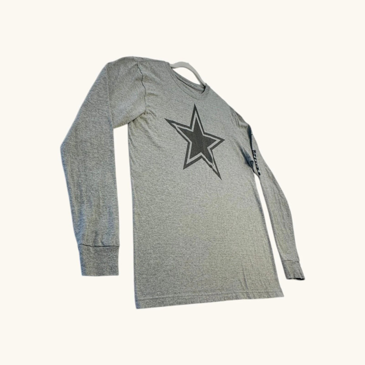 Nike grey long sleeve top featuring Dallas Cowboys star graphic print on soft knit fabric.