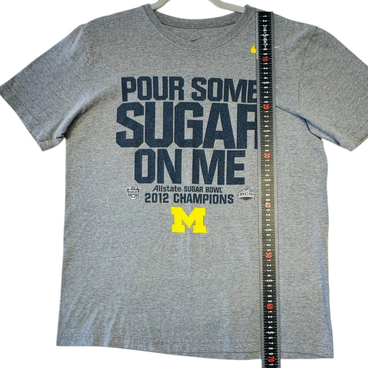 Nike grey Michigan Wolverines t-shirt with bold graphic print and yellow swoosh logo.