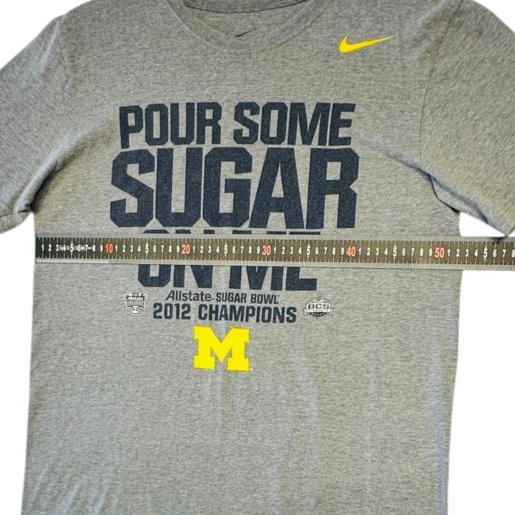 Nike grey Michigan Wolverines t-shirt with bold graphic print and yellow swoosh logo.