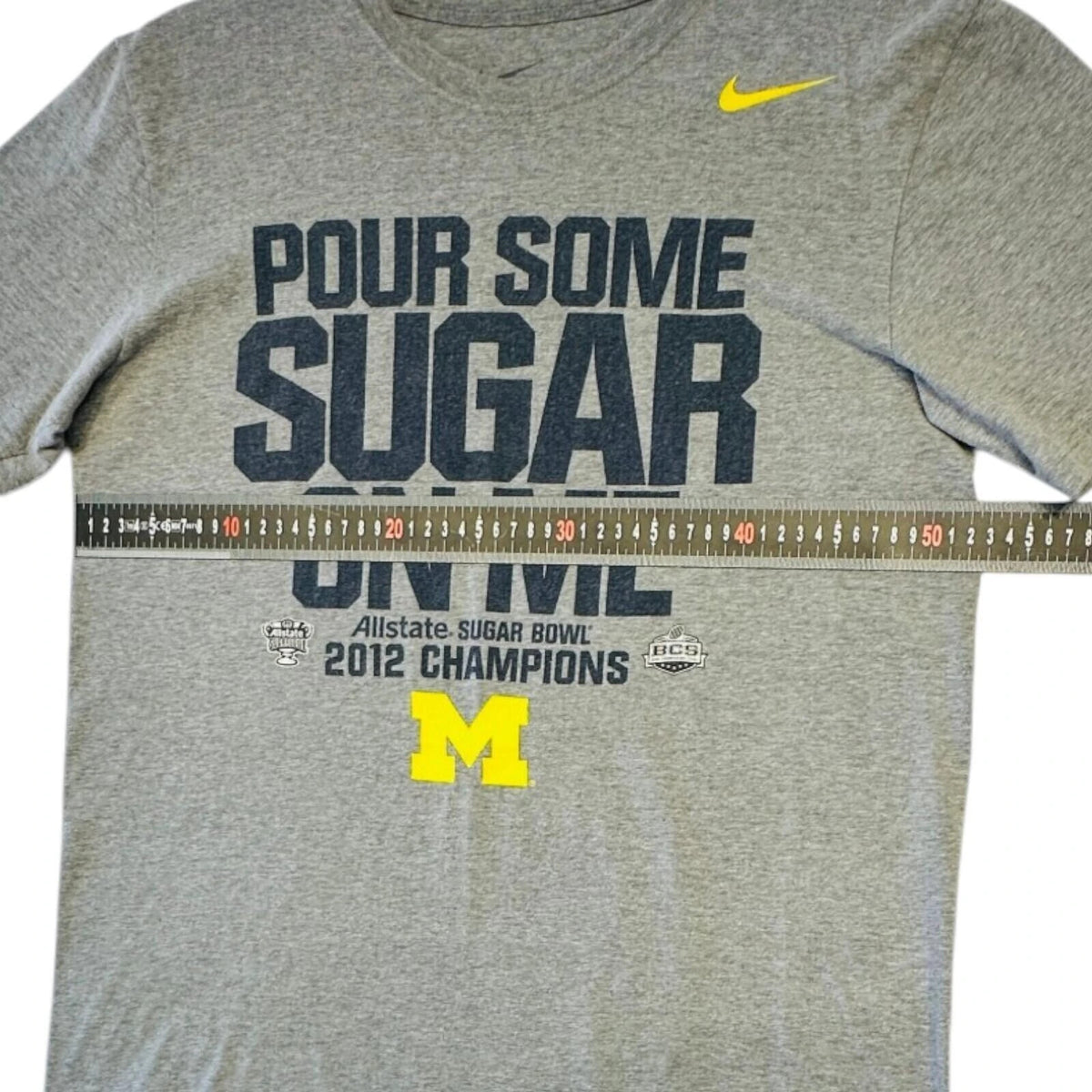 Nike grey Michigan Wolverines t-shirt with bold graphic print and yellow swoosh logo.