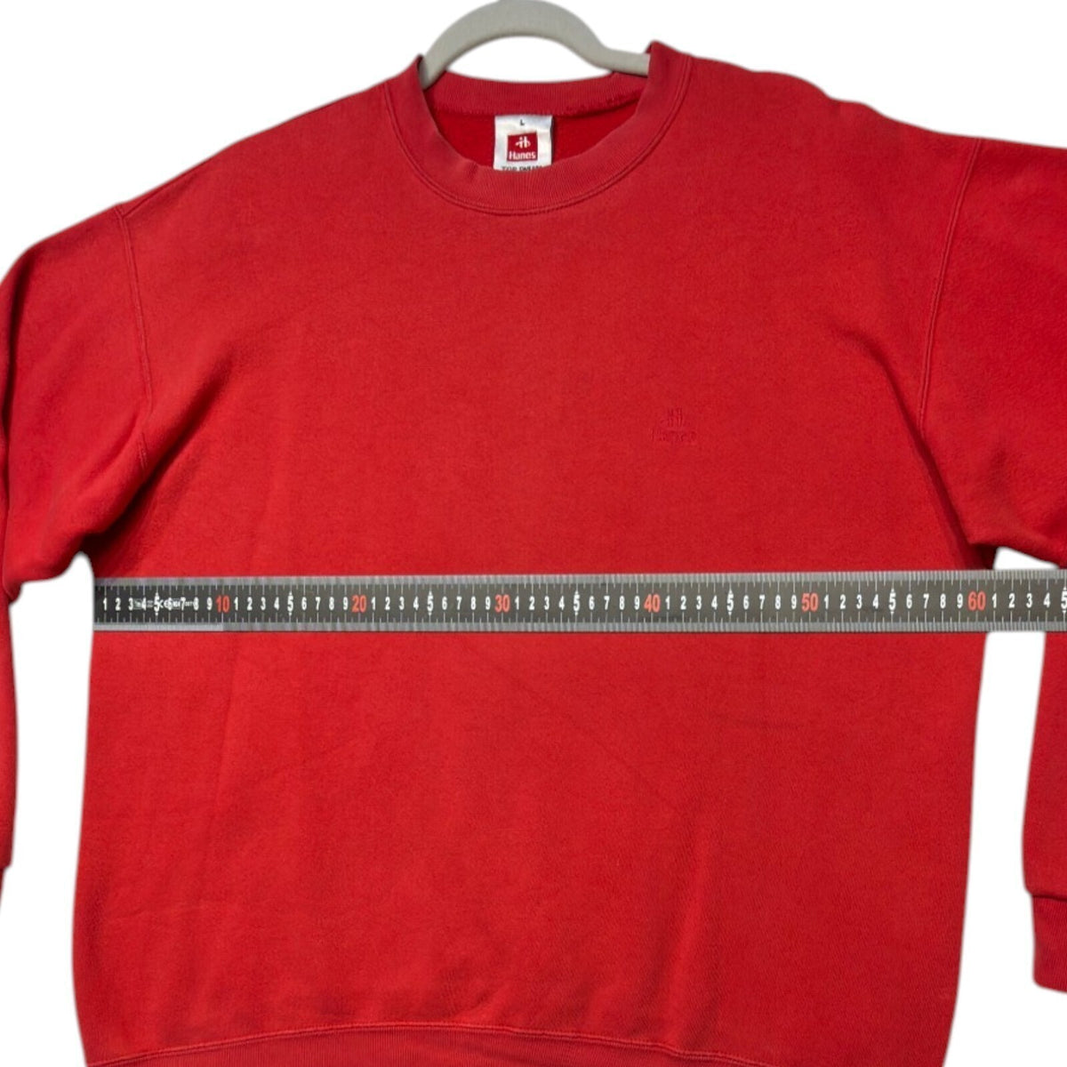 Hanes red crewneck jumper with long sleeves and elasticated cuffs.