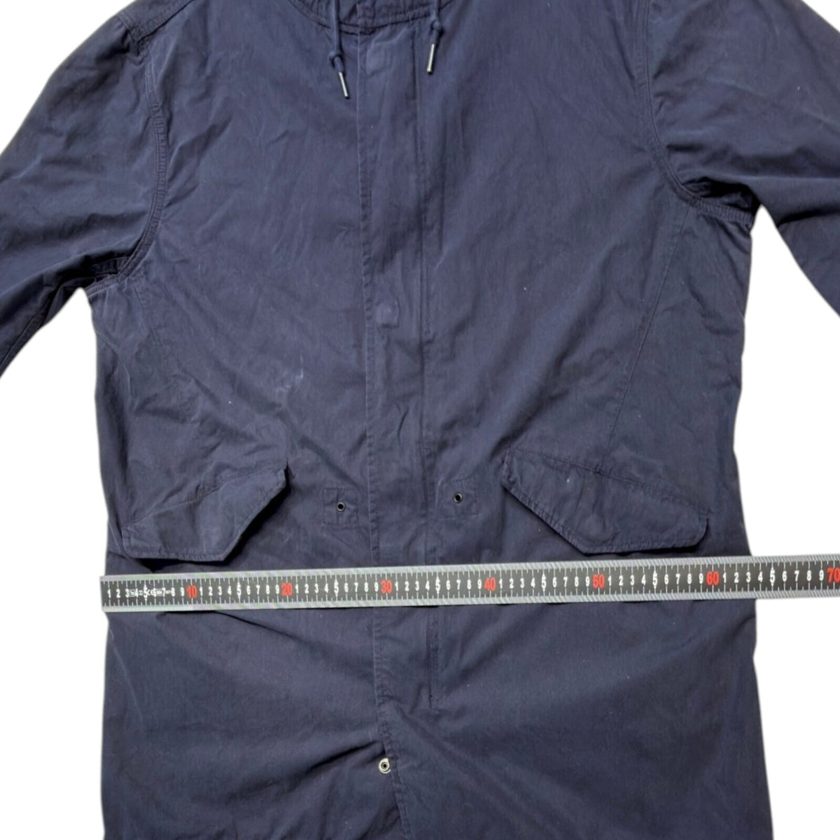 Admiral blue rain coat with drawstring waist, hood, and logo detail.