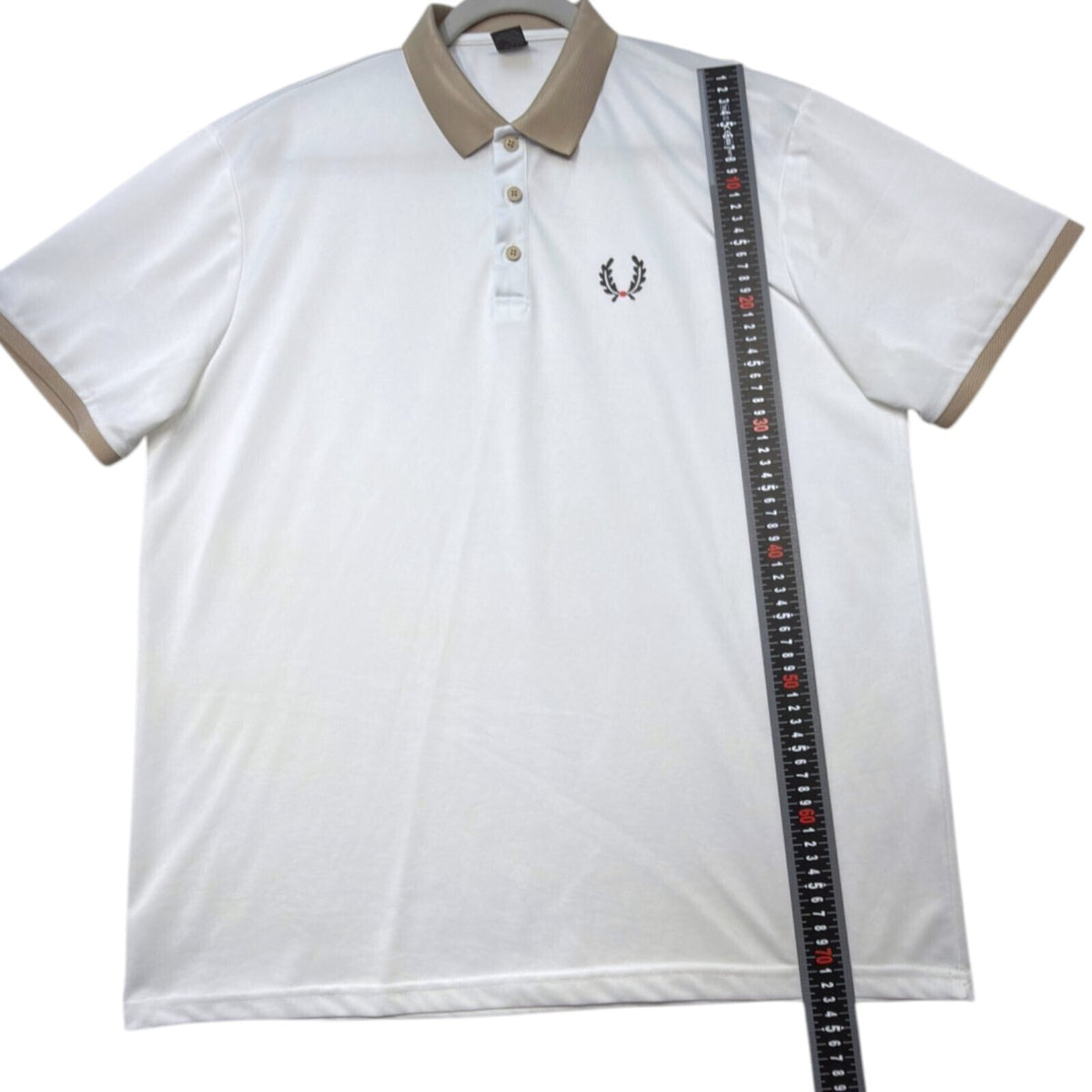 Laurel Wreath white polo shirt with graphic print and structured neckline.