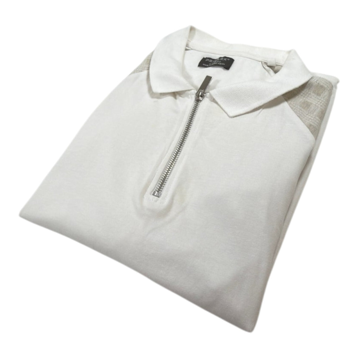Primark beige zip polo shirt with wing collar and contrasting patterned panels.