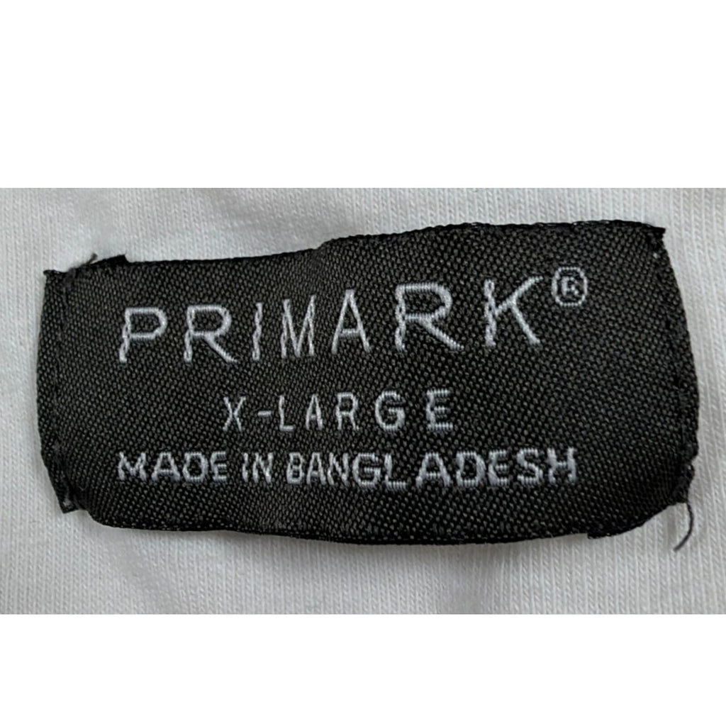 Primark beige zip polo shirt with wing collar and contrasting patterned panels.