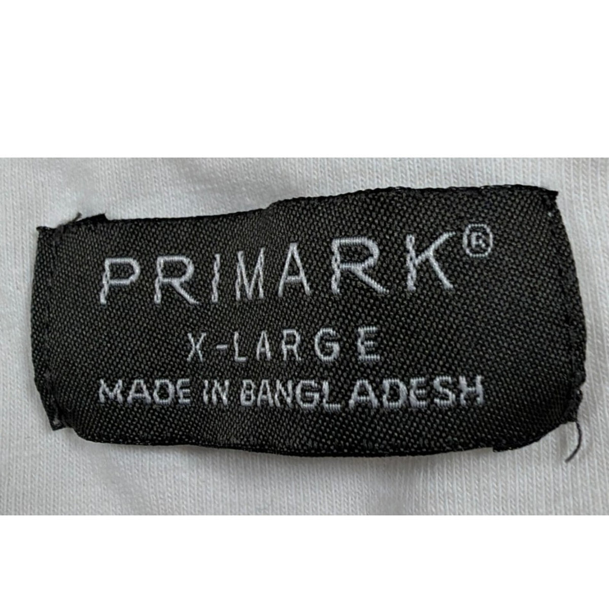Primark beige zip polo shirt with wing collar and contrasting patterned panels.