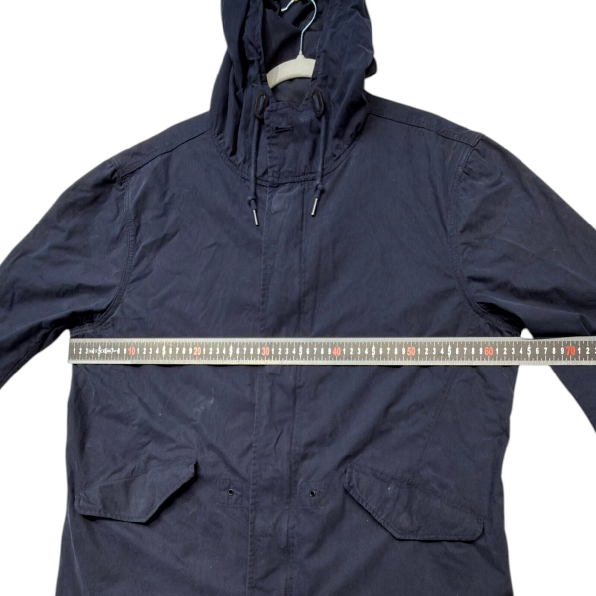 Admiral blue rain coat with drawstring waist, hood, and logo detail.