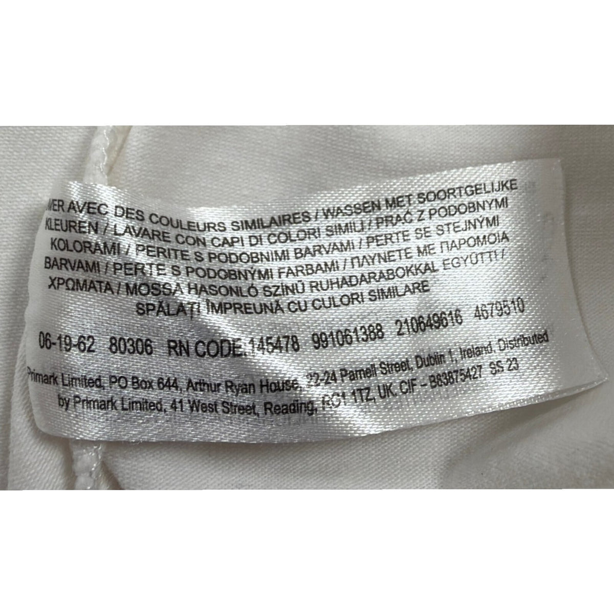Primark beige zip polo shirt with wing collar and contrasting patterned panels.