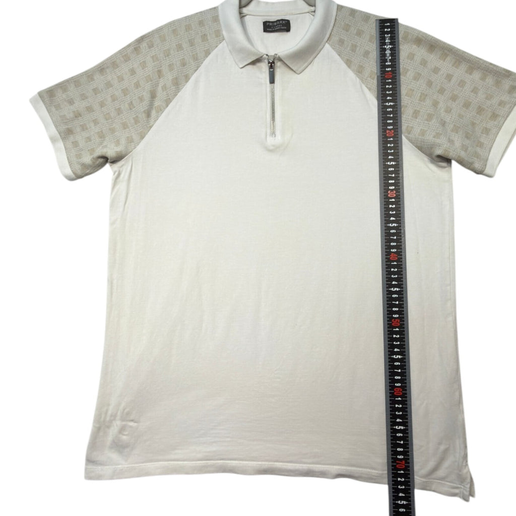 Primark beige zip polo shirt with wing collar and contrasting patterned panels.