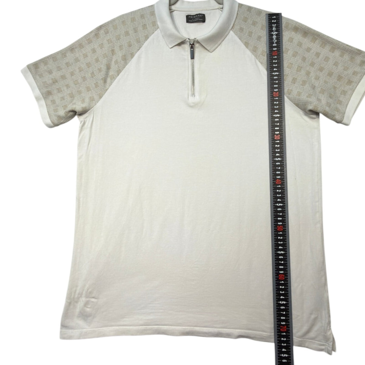 Primark beige zip polo shirt with wing collar and contrasting patterned panels.