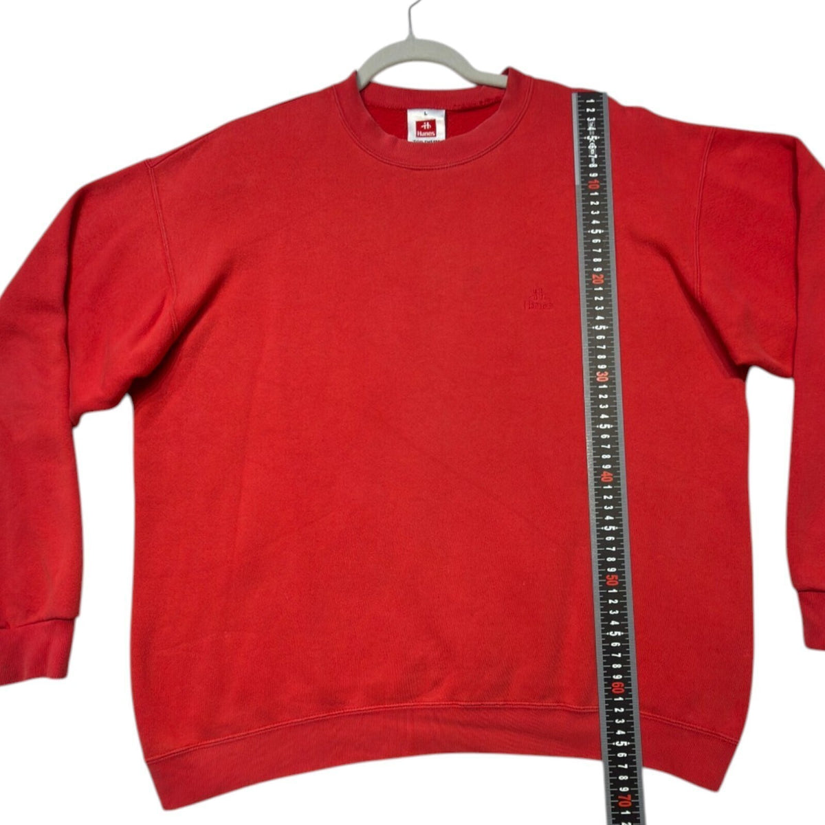 Hanes red crewneck jumper with long sleeves and elasticated cuffs.