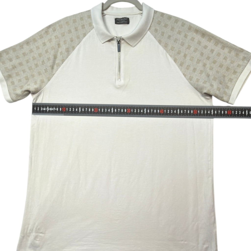 Primark beige zip polo shirt with wing collar and contrasting patterned panels.