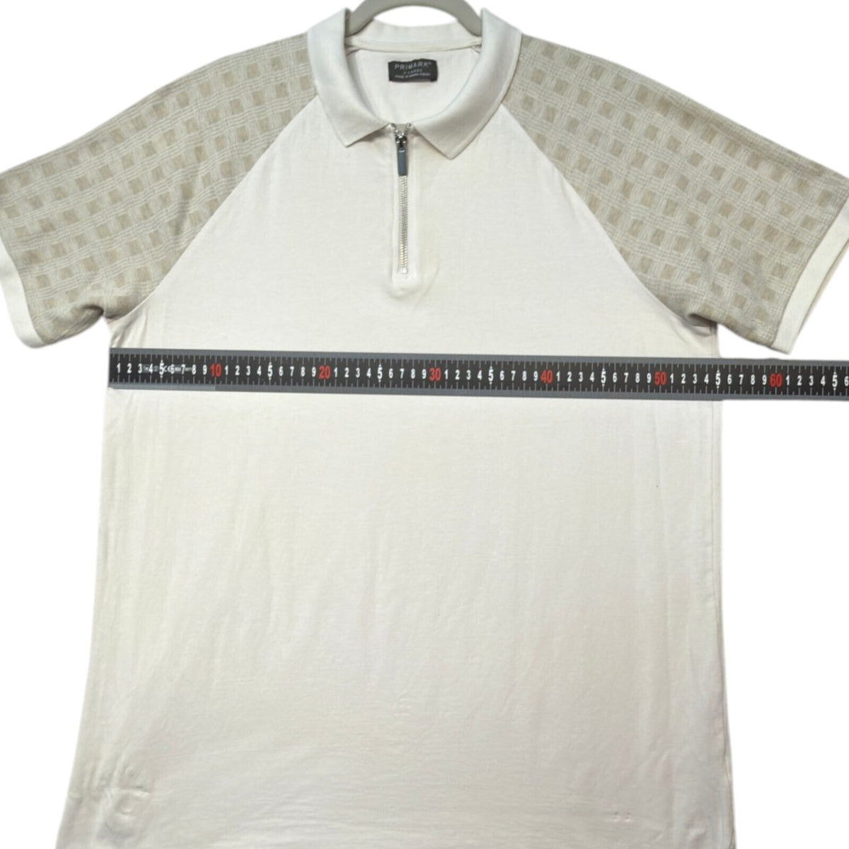 Primark beige zip polo shirt with wing collar and contrasting patterned panels.